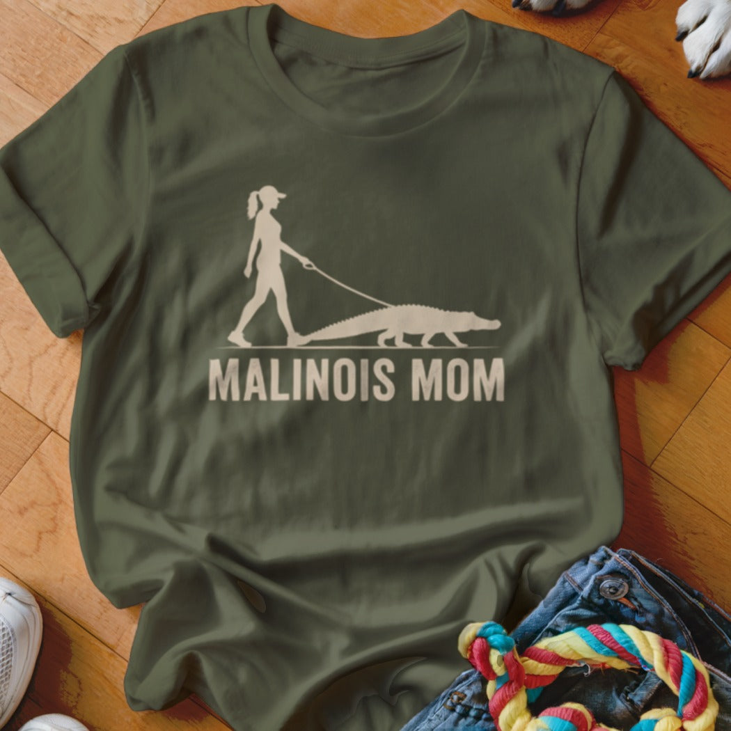 Green t-shirt with graphic of a woman walking an alligator and text "MALINOIS MOM".