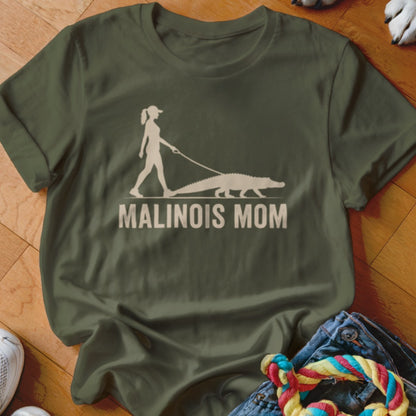 Green t-shirt with graphic of a woman walking an alligator and text "MALINOIS MOM".
