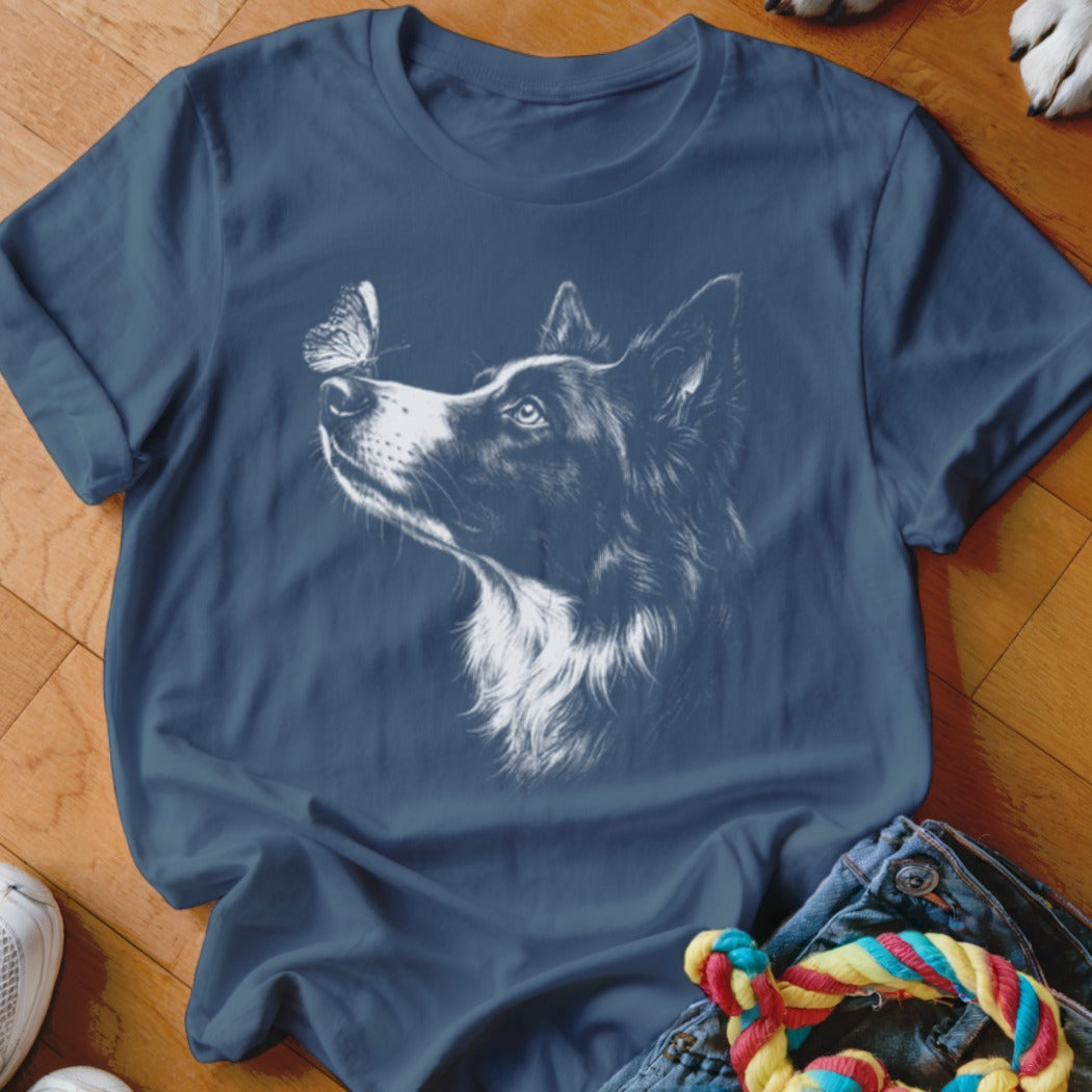Dark blue t-shirt featuring a white line drawing of a dog looking at a butterfly.