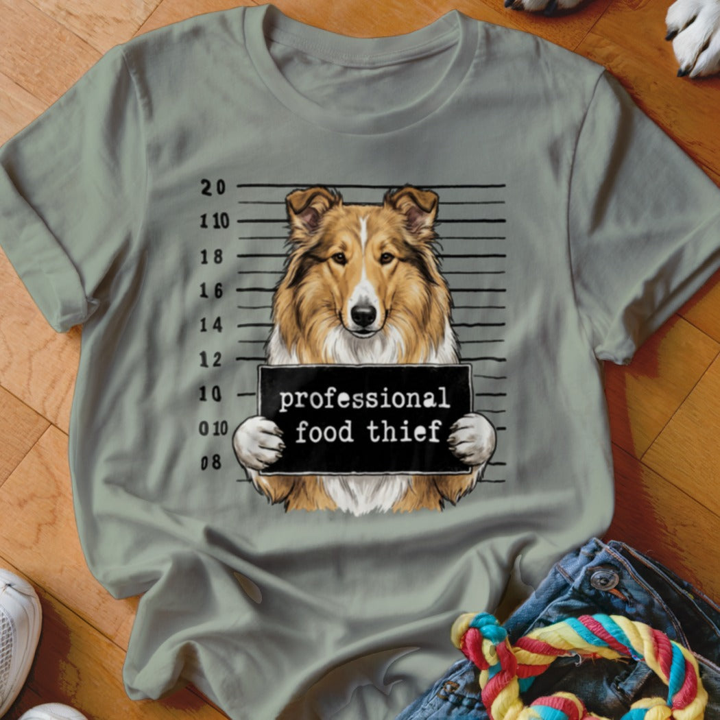 Collie dog mugshot with "professional food thief" sign.