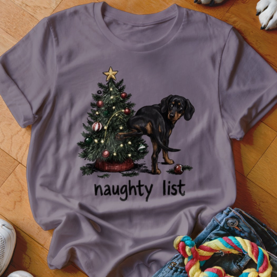 Dachshund dog lifting leg on Christmas tree with text "naughty list".