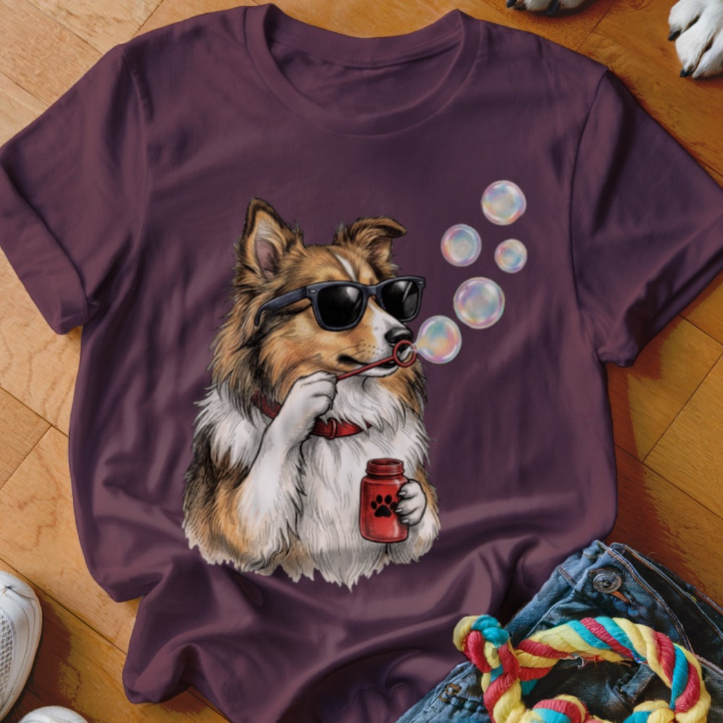 Maroon short-sleeved t-shirt featuring a graphic of a dog wearing sunglasses and blowing bubbles.
