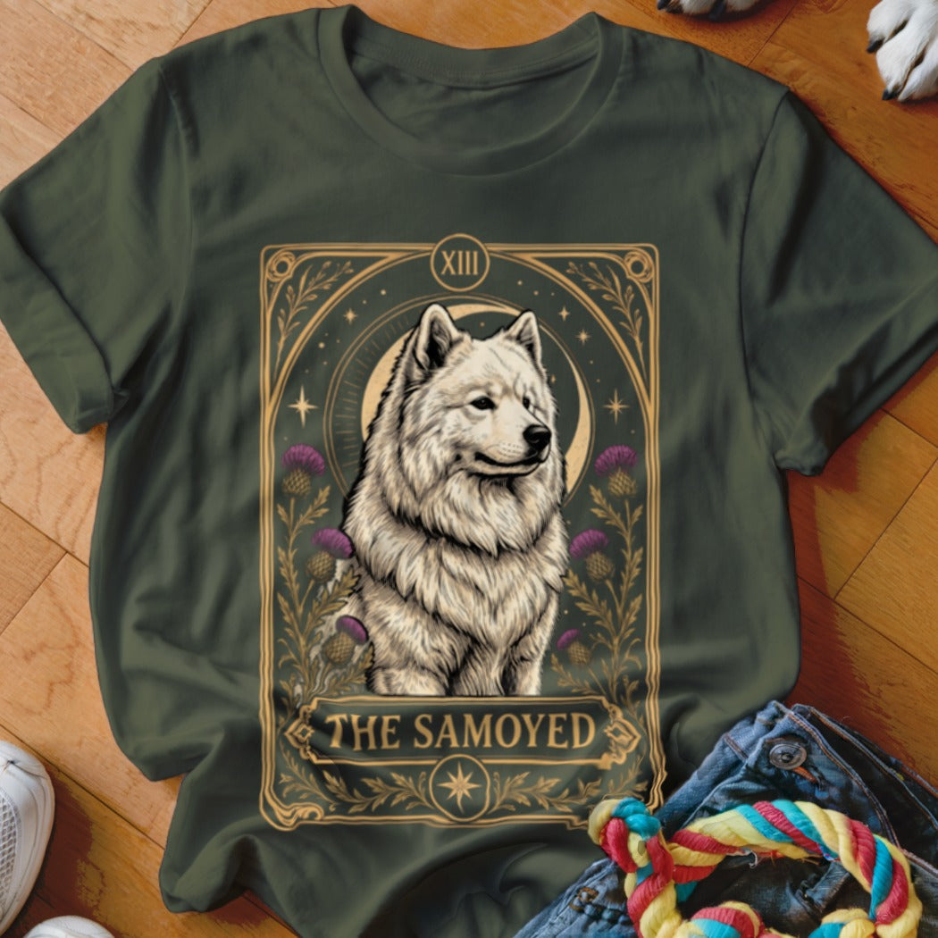 Dark green t-shirt featuring a tarot card graphic of a Samoyed dog surrounded by purple thistle flowers.